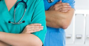 A physicians assistant stands with a doctor