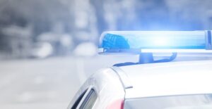 A police car flashes its blue lights
