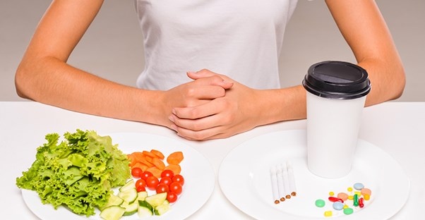 A nutritionist demonstrates healthy food vs unhealthy food