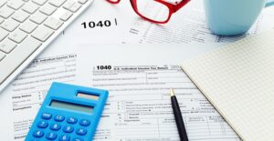 articles of incorporation on a desk with glasses and calculator