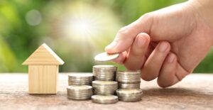 stack of coins and house to represent cost of living
