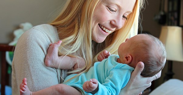Mother holding child. Caring for a baby with cleft lip or palate.