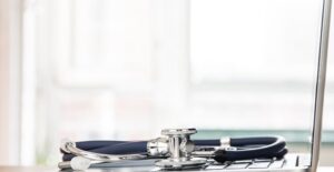 Stethoscope on laptop. Submucous cleft palate.