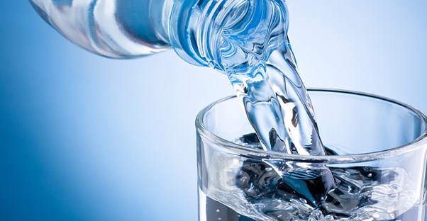 Water being poured into glass. Pancreatitis home remedies.