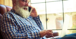 Retired man works from home on a laptop