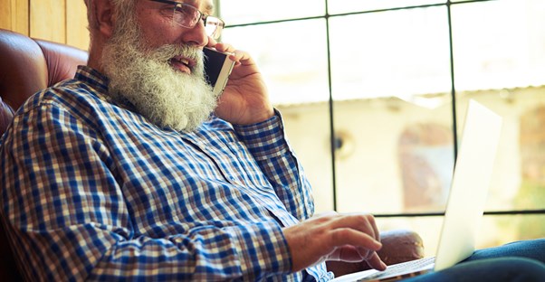 Retired man works from home on a laptop