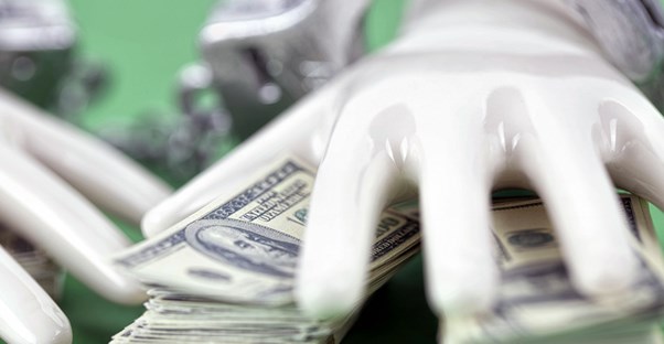 Hand grabbing a pile of cash. Pyramid vs ponzi scheme.
