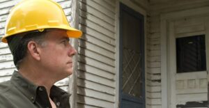 Home inspector looking at house.