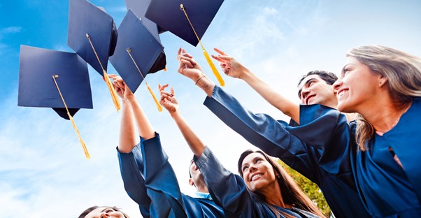 Students throwing up graduation caps