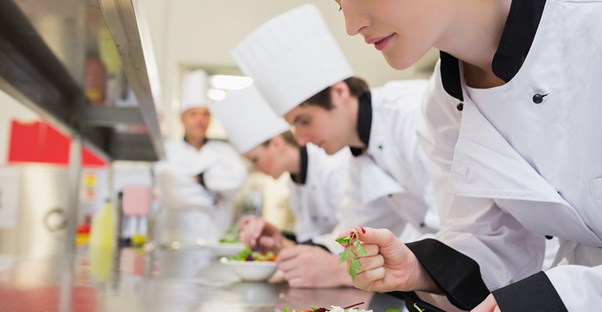 chefs taste their dishes in a professional kitchen