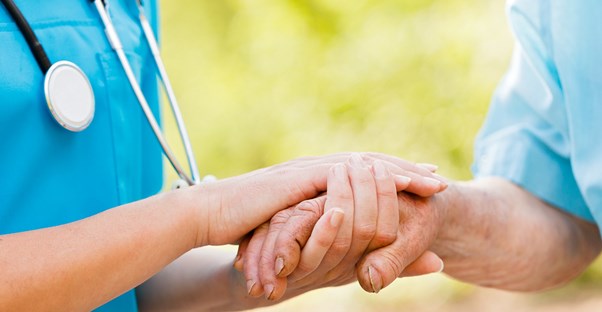 a nurse helps a patient with shingles treatments