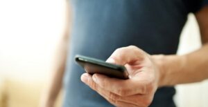 a man checks his phone screen