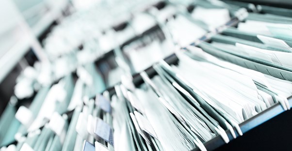 a filing cabinet drawer pulled open to show many medical transcriptions