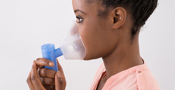 woman using breathing treatment