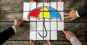 three types of group life insurance. people putting together umbrella puzzle.