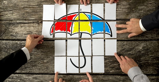 three types of group life insurance. people putting together umbrella puzzle.