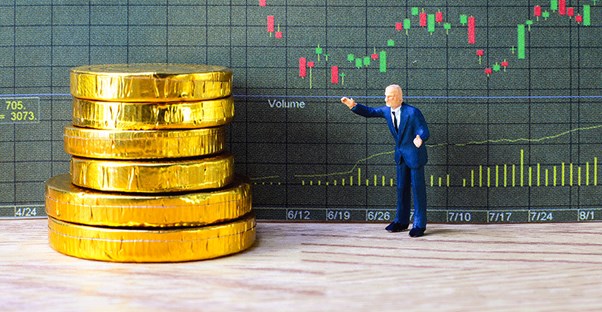 a toy man and a pile of coins symbolize index funds and money market funds