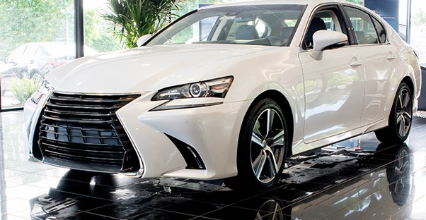 a white 2017 lexus gs in a dealership showroom
