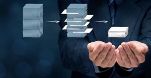 a concept image of a man holding stacks of paper symbolizing business analytics