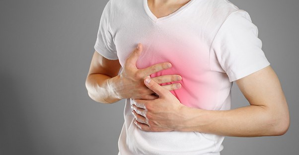 a man holds his chest that glows red symbolizing a pulmonary embolism