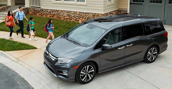 a slate colored 2018 honda odyssey in a driveway