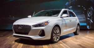 a white 2018 hyundai elantra in a showroom
