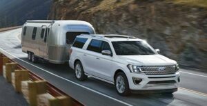 a white 2018 ford expedition pulling an airstream