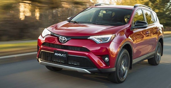 a 2018 toyota rav4 driving down the road