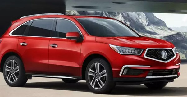 a red acura mdx in a driveway