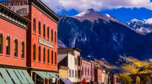 building backed by a mountain drop