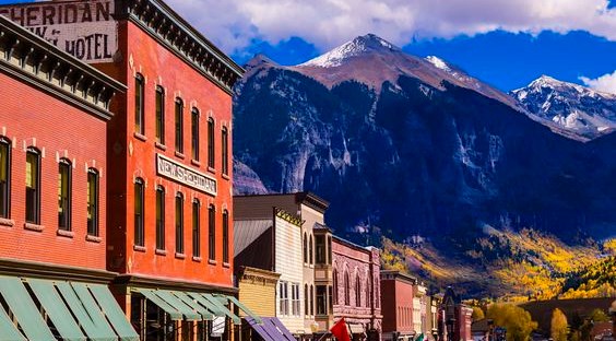 building backed by a mountain drop