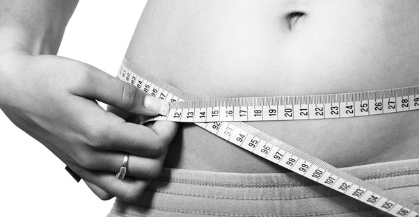 person measuring waist