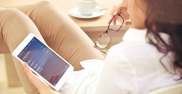 Woman moving her checking account on her tablet