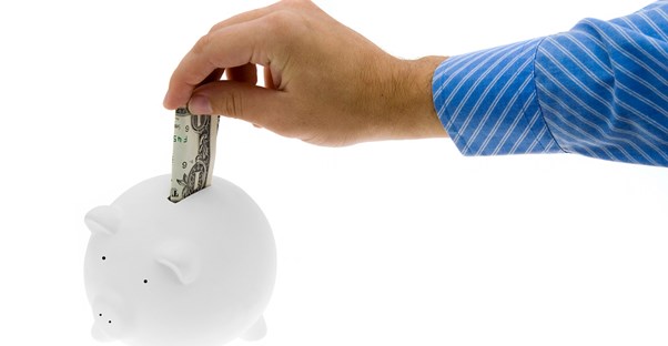 man saving money in a piggy bank