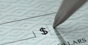 Pen writing a check