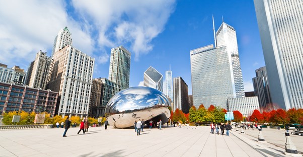 millennium park and the cloud gate sculpture against a backdrop of the chicago skyline