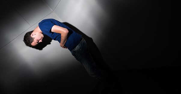 a man holds his stomach from crohns disease pain