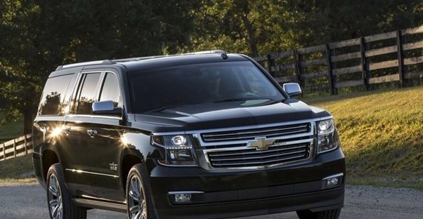 a black 2019 chevrolet suburban driving down the road