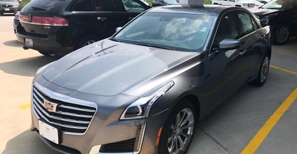 a gray cadillac cts at a car dealership