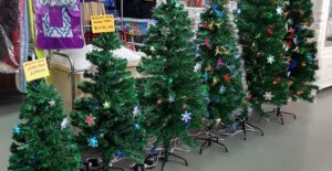 row or christmas trees in a store