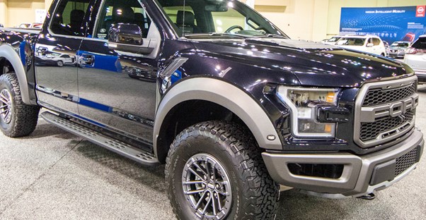 a black 2019 ford f150 in a showroom