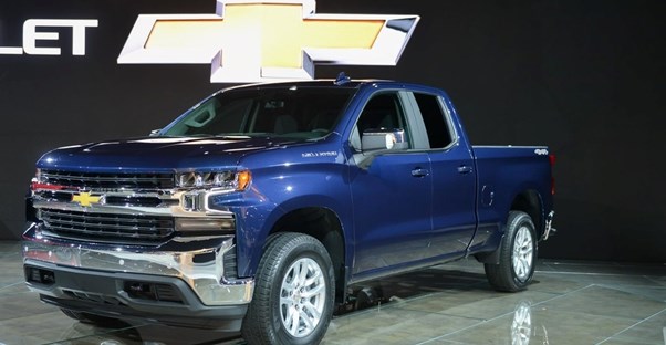 a blue 2019 chevrolet silverado 1500 on an auto show stage