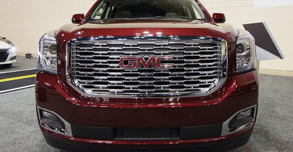 a red 2019 gmc yukon at an auto show
