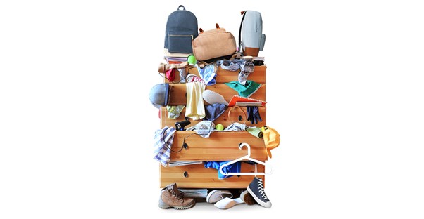 cluttered chest of drawers