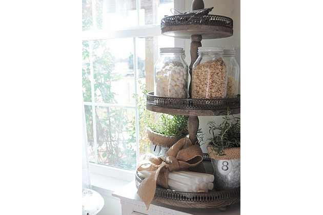 Use a decorative cake stand to organize the bathroom.