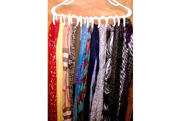 Utilize shower rings to hold scarves on a single hanger.