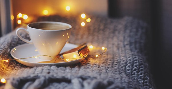 Hot cup of cocoa on a fluffy, warm blanket.
