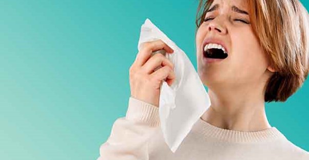 Woman with a cold sneezing.