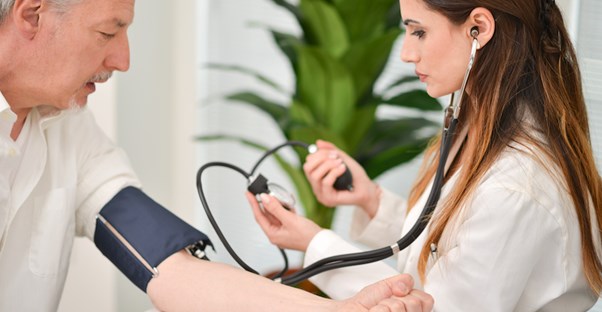man getting his blood pressure checked