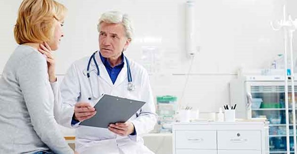 A woman talks with her doctor about what health screenings she should be getting.